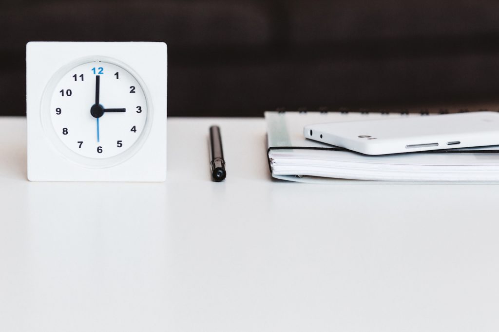 Clock, pencil and a book